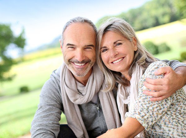 Older man and woman outdoors smiling
