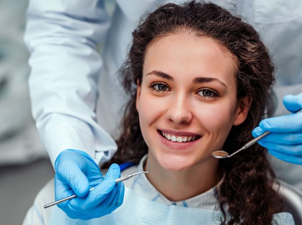 smiling young woman in dental chair 