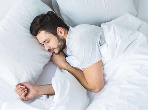 Man snoring while sleeping in bed