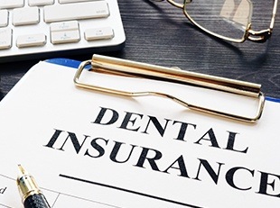 Dental insurance forms on clipboard