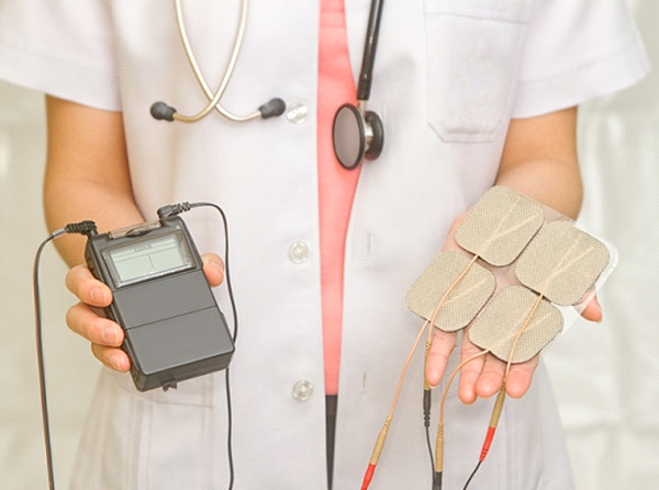 Doctor holding machine for TENS therapy and electrodes