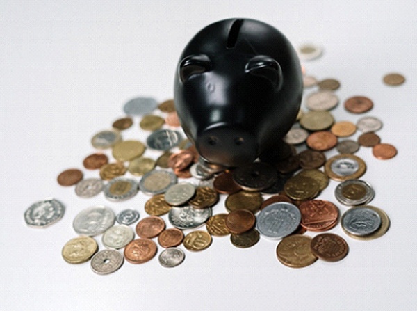 Black piggy bank and loose coins