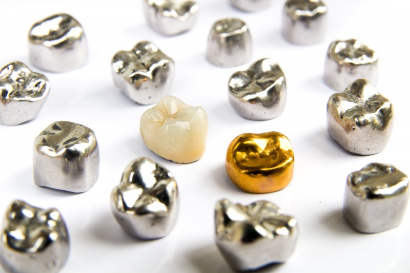 dental crowns of various materials lying on a table