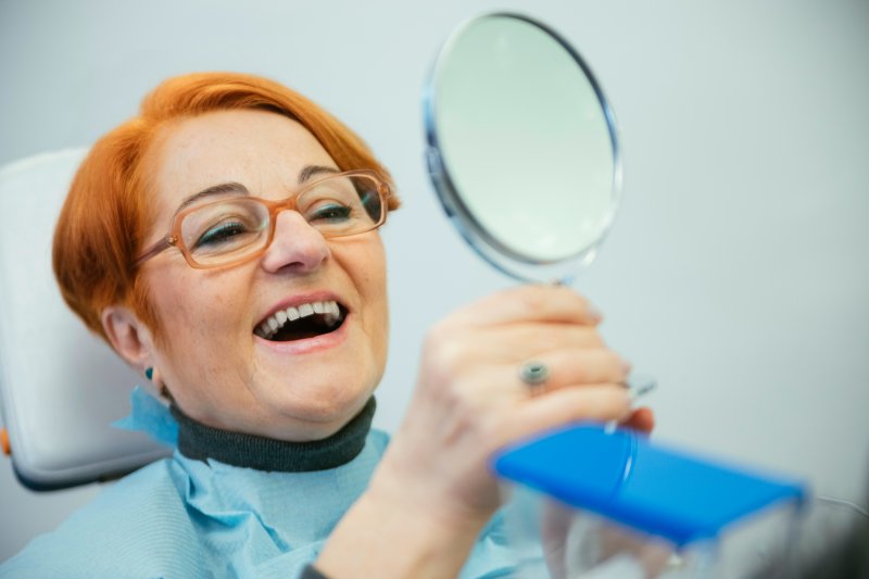 patient looking at their new dentures