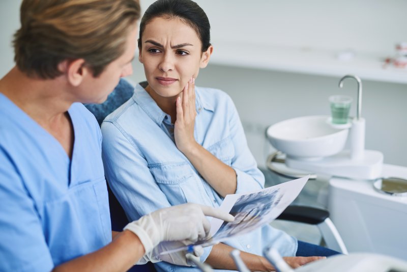 woman whose dental bridge fell out in Leesburg holding cheek