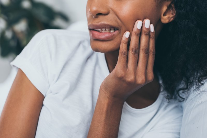 Woman in white shirt with a TMJ disorder