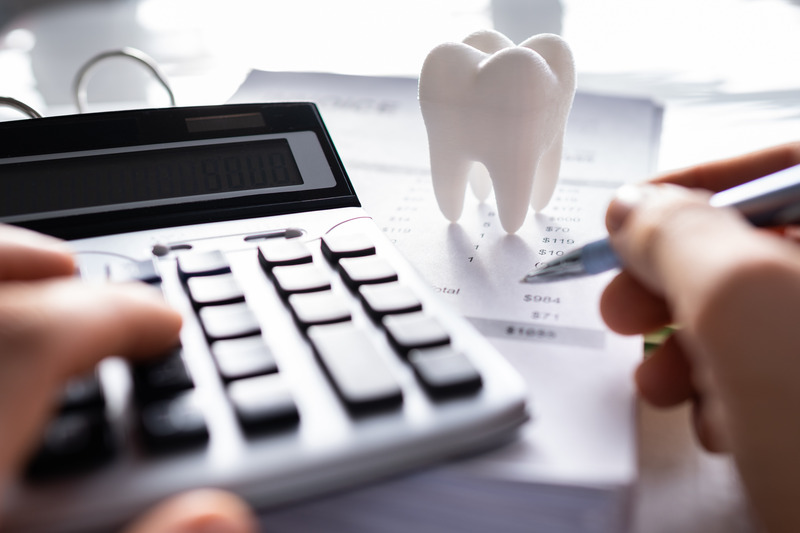 Patient calculating the costs of dental implants