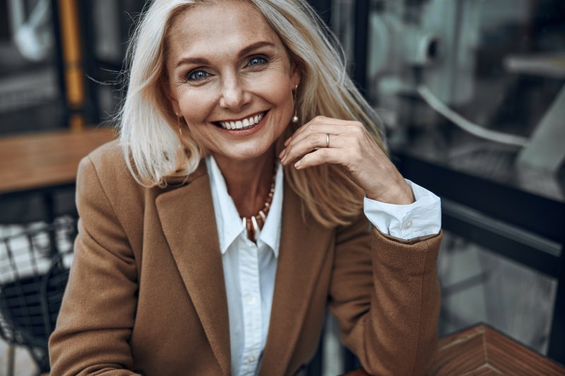 Woman smiling after full mouth reconstruction