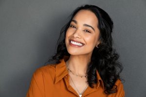 Woman smiling after receiving gum disease therapy.